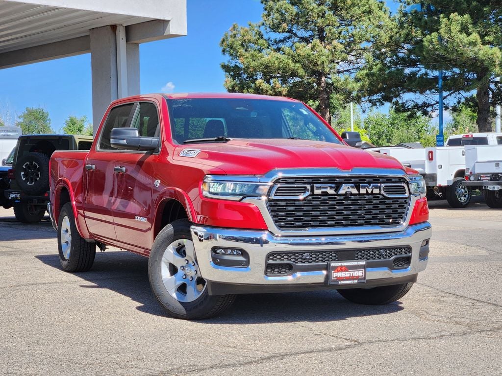 2026 RAM 1500 RAM 1500 BIG HORN CREW CAB 4X4 5'7' BOX in Molten Red Pearl-Coat Exterior Paint — front three-quarter view